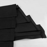 Stack of black fabric panels on a white background