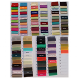 A color chart showing fabric swatches in labeled shades like red, lavender, mint, navy, and fuchsia, arranged in a grid. Each swatch has a crimped edge, conveying a vibrant and varied palette.