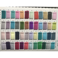 A grid of colorful fabric swatches numbered 697 to 744, displaying a spectrum from pastels to vibrant hues. The swatches are neatly arranged, creating a visually appealing array.
