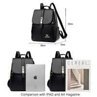 A stylish black backpack with gold accents, shown beside an iPad and an A4 magazine for size comparison. Dimensions noted are 32cm x 26cm x 14cm.