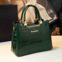 A stylish green crocodile-embossed handbag with gold accents and a logo, set against a blurred background.