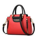A stylish red handbag with black accents, featuring dual handles and a detachable shoulder strap, adorned with gold hardware.