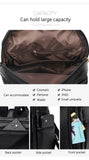 Black multifunctional bag with large compartments for cosmetics, electronics, and personal items; features various pockets for easy access.