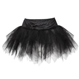 Black tulle tutu skirt with a satin waistband. The skirt has layers of sheer, ruffled fabric creating a voluminous and playful appearance.