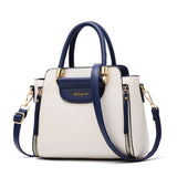 Chic cream and navy handbag with gold accents, featuring double handles and a removable strap, ideal for stylish everyday use.
