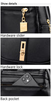 Close-up of a black bag showcasing a gold hardware slider, lock, and a back pocket with a partially visible smartphone.