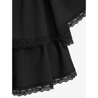 Close-up of a black dress with two layered hems, each trimmed with delicate lace. The fabric appears smooth and elegant, conveying a classic, refined tone.