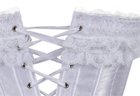 Close-up of a white satin corset with intricate lace trim and crisscrossed white lacing through silver eyelets, conveying elegance and vintage style.