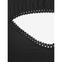 Close-up of black fabric with a triangular cutout. Detailed with delicate, scalloped black lace trim, creating a subtle and elegant contrast.