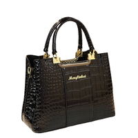 Elegant black crocodile-embossed handbag with gold hardware and a logo, featuring dual handles and a structured silhouette.