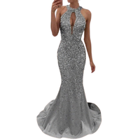 Elegant silver sequined mermaid gown with a halter neck and keyhole cutout. The dress features a fitted silhouette and a flowing train.