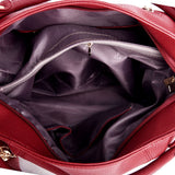 Inside view of a red leather handbag with a purple lining and multiple compartments, including a zippered pocket.