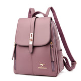 Lavender faux leather backpack with a flap closure, gold hardware, and side zippers, featuring a kangaroo logo. Stylish and functional.