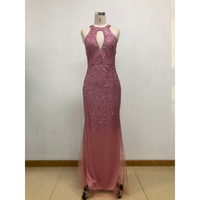 Pink sequined evening gown on mannequin; features a keyhole neckline and fitted silhouette, exuding elegance and glamour against a plain backdrop.