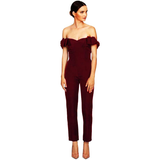 Elegant woman in a maroon off-shoulder jumpsuit, standing gracefully. Her hair is neatly tied back, and she wears nude heels. Minimalist and poised.