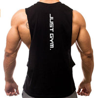 A muscular man wearing a sleeveless black tank top with "JUST GYM." printed vertically on the back, showcasing his strong physique.