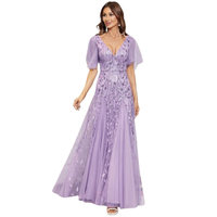 Woman in an elegant lavender evening gown with a deep V-neckline, sheer short sleeves, and floral embroidery, exuding a graceful and sophisticated vibe.