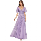 Woman in an elegant lavender evening gown with a deep V-neckline, sheer short sleeves, and floral embroidery, exuding a graceful and sophisticated vibe.