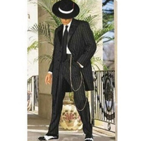 Man wearing a vintage black pinstripe zoot suit with a wide-brimmed hat and chain accessory. He stands elegantly next to a potted plant, exuding a retro vibe.