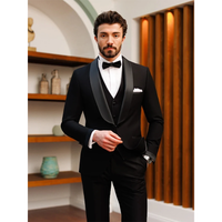 A well-groomed man in a black tuxedo with a bow tie stands confidently indoors, evoking elegance. Warm wood and decorative items create a sophisticated backdrop.