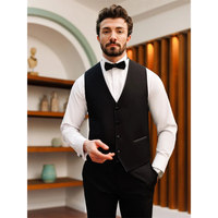 Man in a black vest and bow tie stands confidently in a stylish room with shelves and wooden paneling. His expression is calm and composed.
