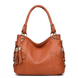 A stylish brown leather handbag with a slouchy design, featuring gold hardware and a decorative tassel charm.