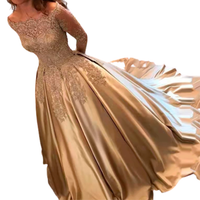 Woman in an elegant champagne-colored gown with intricate lace detailing and a flowing train. The pose conveys grace and sophistication.