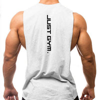 A muscular man wearing a sleeveless gray shirt with "JUST GYM." printed vertically on the back, showcasing his toned physique.