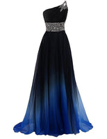 A flowing, elegant evening gown fades from black to blue at the hem. It features a one-shoulder design, embellished waist, and a sheer, ethereal texture.
