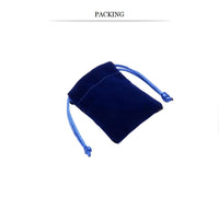 Dark blue velvet pouch with light blue drawstrings, lying on a white background. The simple design suggests elegance and functionality.