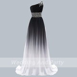 Elegant one-shoulder gown with a gradient from black to white, featuring a rhinestone-embellished shoulder and waist, conveying sophistication.
