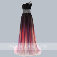 One-shoulder gown with gradient colors, transitioning from black to soft pink, adorned with floral beadwork on shoulder and waist, elegant and formal.