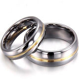 Two polished silver rings with gold inlays lie overlapping on a white background, symbolizing unity and elegance. The rings' shine conveys a sense of romance.