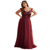 Woman in an elegant, lavender evening gown with a sequined bodice and flowing tulle skirt, exuding a graceful and sophisticated tone.
