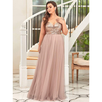 Woman in elegant pink gown with sequin bodice stands by a white spiral staircase. The setting is luxurious, with a serene, stylish ambiance.