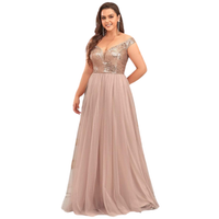 Woman in elegant, floor-length gown with a sequin-embellished bodice and flowing tulle skirt, posing confidently against a white background.
