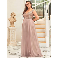 Woman in an elegant, floor-length, sleeveless dress with a sparkling bodice poses near a staircase and a classical statue. The mood is sophisticated.