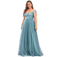 Woman in an elegant off-shoulder teal gown with a sequin bodice and flowing skirt, smiling confidently. The tone is glamorous and joyful.