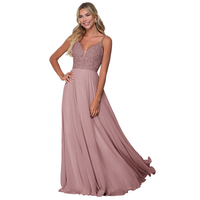 Smiling woman in an elegant, sleeveless, dusty rose gown with intricate beadwork on the bodice, flowing skirt. Radiates grace and confidence.